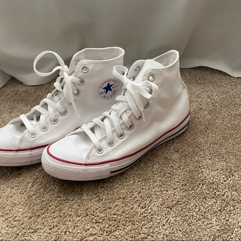 White Chuck Taylor High top converse.